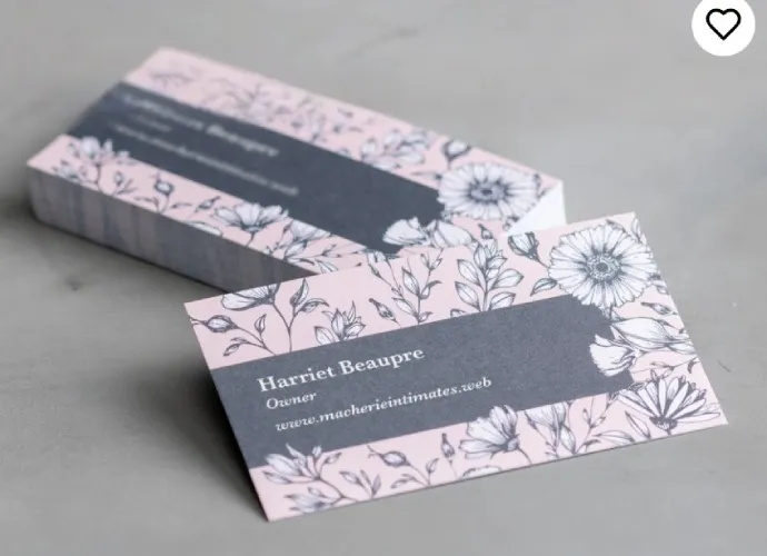 Recycled paper business cards with pink flower print.