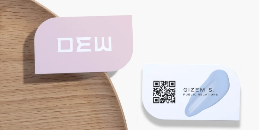 Leaf-shaped business card with QR code.
